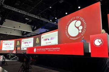 Large red-decorated podium with Elizabeta Nemeth presenting