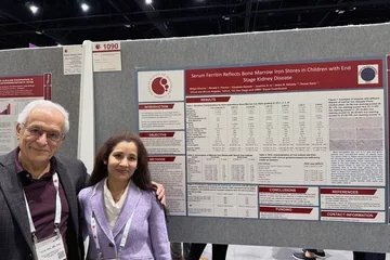 Scientific poster with Sharma Shilpa and Tomas Ganz standing next to it