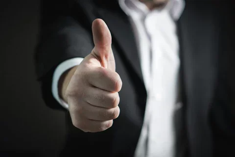 An outstreached arm gives a thumbs up.