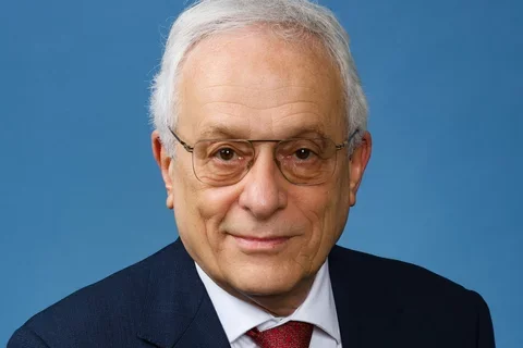 Tomas Ganz (older male in a jacket and tie)
