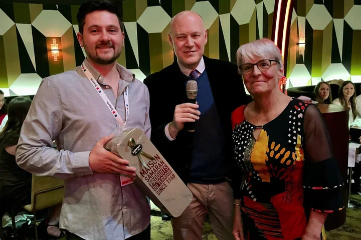 Gabriel Karin receiving the first prize souvenir from two organizers