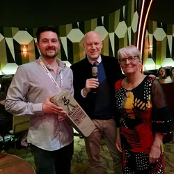 Gabriel Karin receiving the first prize souvenir from two organizers